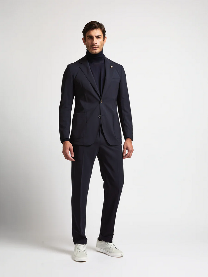 Male model wearing black Tombolini Zero Gravity Suit with white shoes