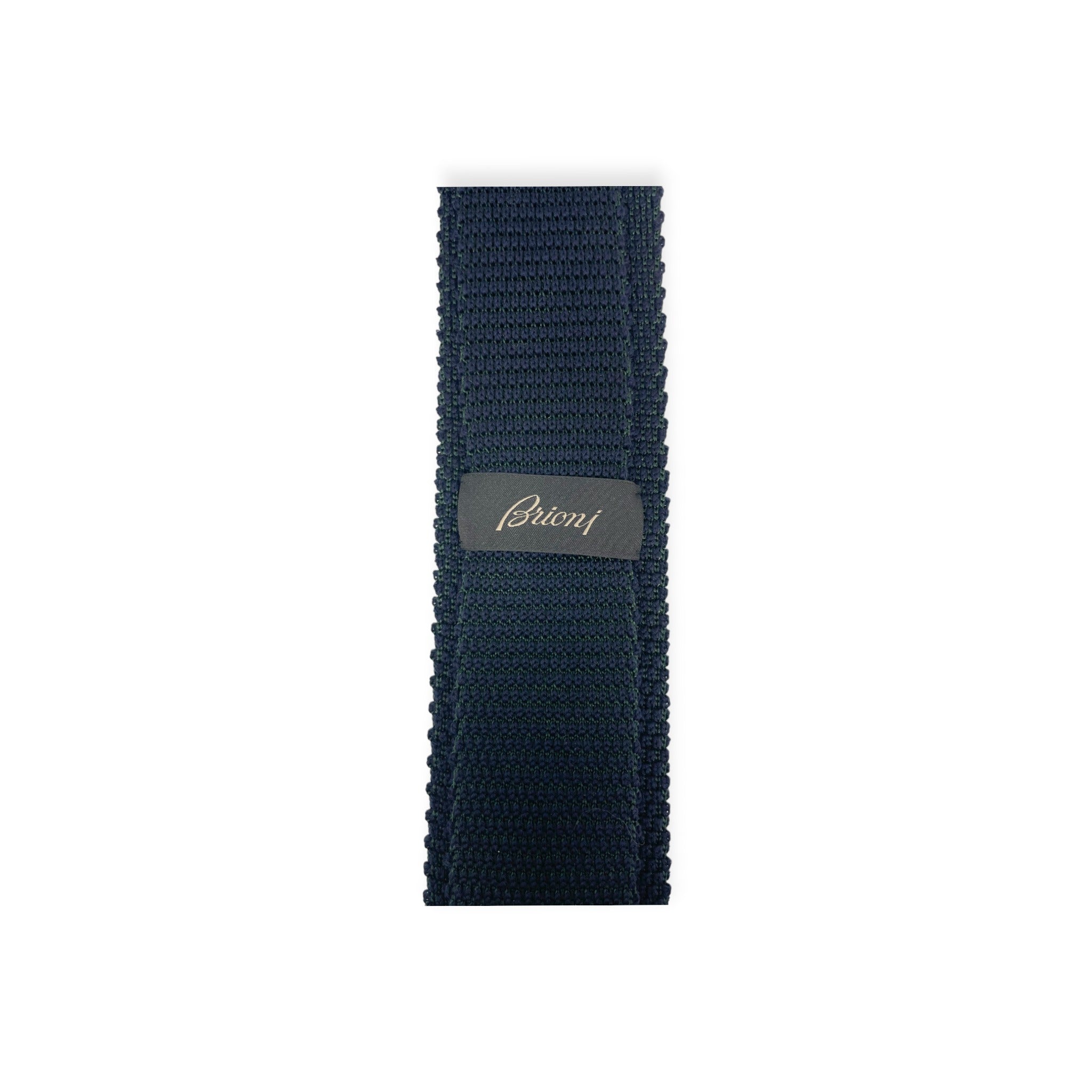 Top down view of blue Brioni knit tricot tie showing label